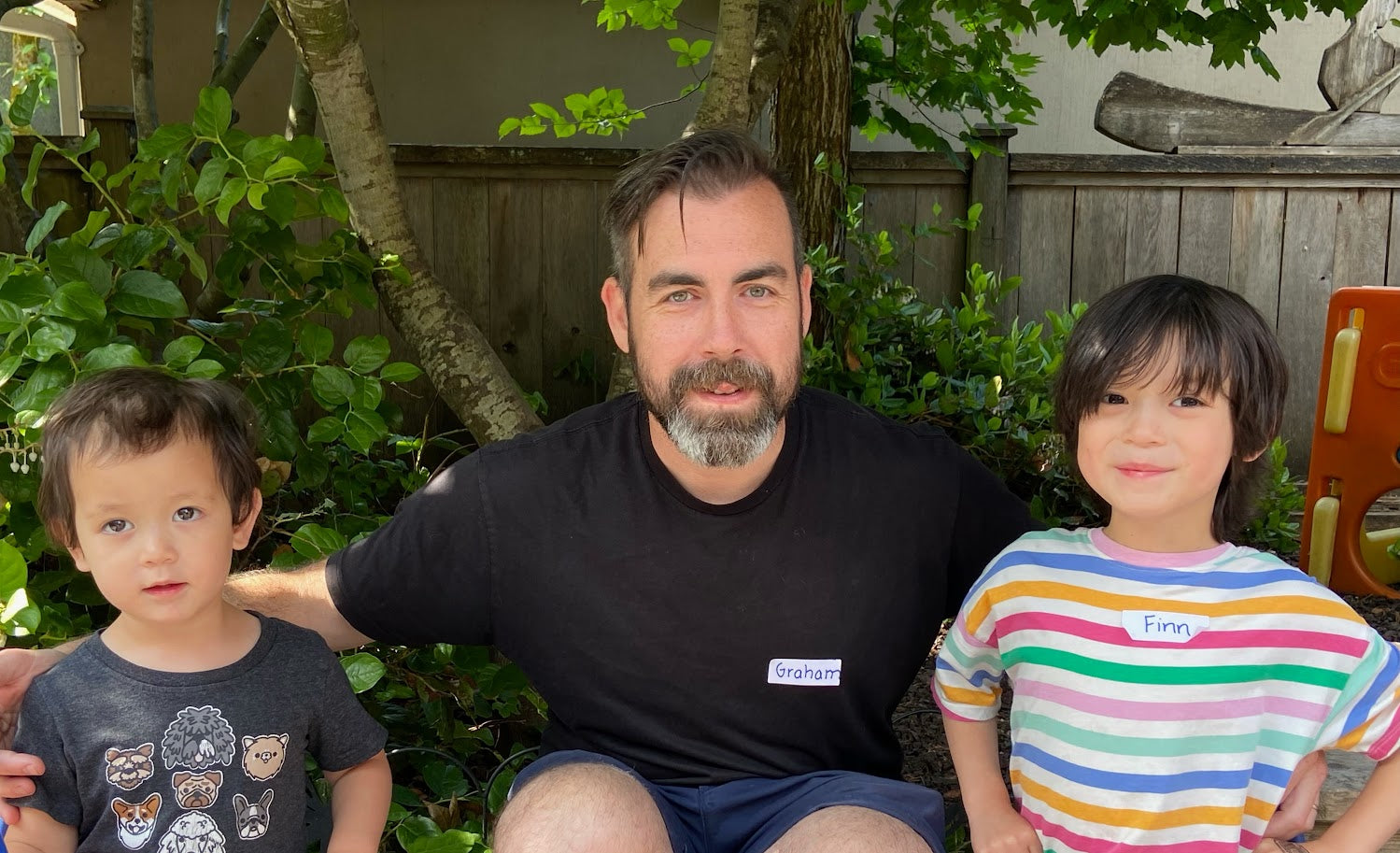 A father with his two sons, highlighting their journey with Montessori education and the impact on their learning and development